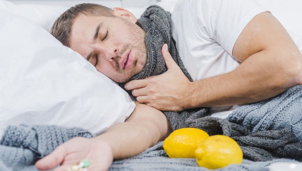 young-man-suffering-from-cold-lying-bed-with-pills-his-hand (1) (2)
